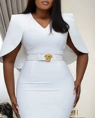A woman wears a white knee-length bodycon dress with cape sleeves and a V-neckline.