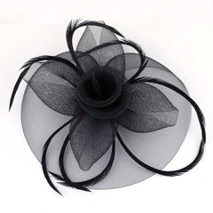 A black mesh fascinator headband featuring a central fabric rose and decorative feathers.