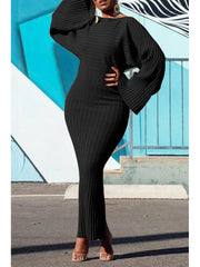 A woman wears a black, long-sleeved, ribbed knit bodycon dress with batwing sleeves.