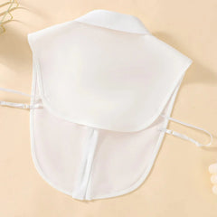 A white detachable shirt collar made of polyester with adjustable side straps.