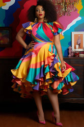 A woman wears a colorful, satin, A-line midi dress with petal sleeves and ruffled hem.