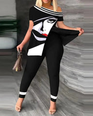 A woman wears a black two-piece set featuring an off-shoulder top with a graphic face print and matching skinny trousers with white hem accents.