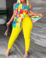 A woman wears a two-piece set featuring a colorful abstract print top and solid yellow leggings.