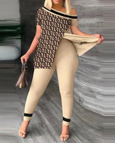 A woman wears a beige two-piece set featuring a geometric print top with an asymmetrical neckline.