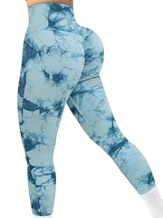 A person wears high-waisted, ankle-length blue tie-dye seamless leggings with a textured finish.