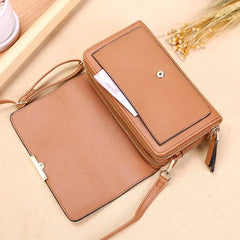 A tan faux leather women's wallet with a detachable shoulder strap and a zippered compartment.