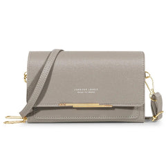 A grey rectangular women's shoulder bag with a gold metal accent and a detachable strap.