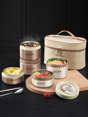 A set of beige and khaki stainless steel lunch containers with a matching insulated carry bag.