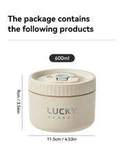 A round, beige, 600ml insulated lunch box with a lid and the word Lucky printed on the front.
