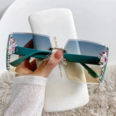 Rimless rectangular sunglasses with green gradient lenses and decorative crystal embellishments.