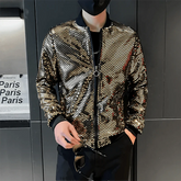 A man wears a gold sequined bomber jacket with a stand collar and black ribbed cuffs.