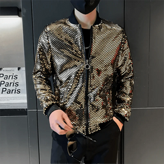 A man wears a gold sequined bomber jacket with a stand collar and black ribbed cuffs.