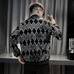 A man wears a black bomber jacket featuring a silver sequined diamond pattern.