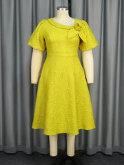 A yellow jacquard midi dress with an asymmetrical neckline, 3D flower detail, and puff sleeves.