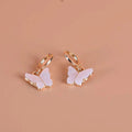Pink butterfly pendant earrings by Showlu Fashion, alloy ear clips with delicate butterfly design and natural gemstone accents.