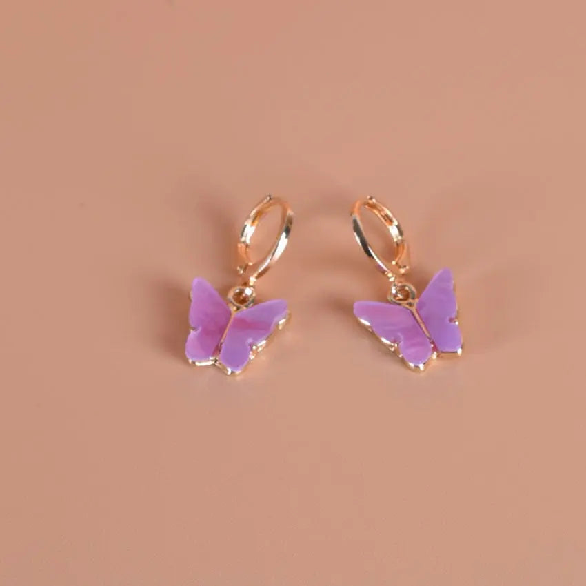 Pink butterfly pendant earrings by Showlu Fashion, alloy ear clips with a delicate butterfly design for a stylish look.