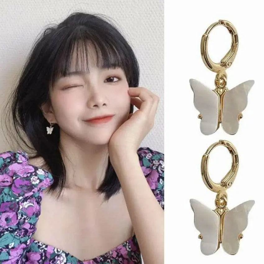 Pink butterfly pendant earrings by Showlu Fashion, alloy ear clips with a delicate, natural butterfly design.