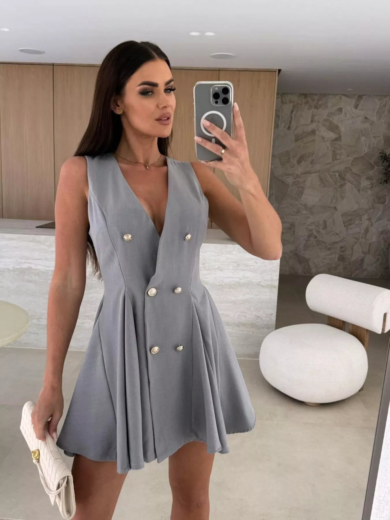 Double-breasted V-neck mini dress by Trendsi featuring long sleeves and a fitted silhouette, shown on a mannequin.