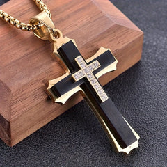 A gold-plated stainless steel cross pendant featuring a black inlay and a central zircon cross.