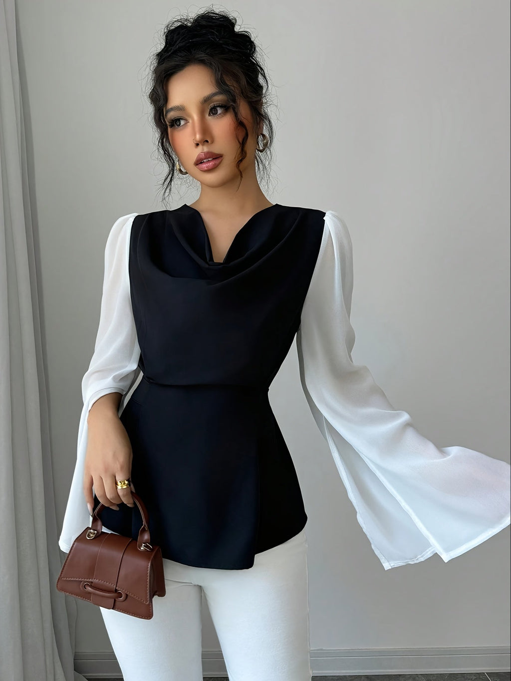 SHOWLU Women's black and white pleated asymmetrical long sleeve blouse with stylish design and flowing fabric.
