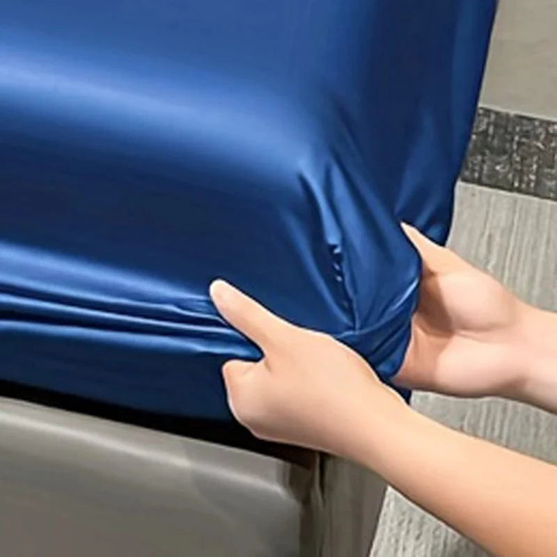 Showlu Fashion satin fitted sheet in solid ice silk color, modern and smooth bedding for a stylish bedroom.