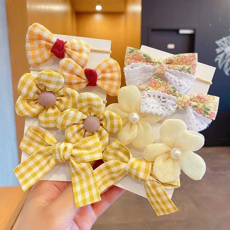 Set of 10 big bow flower elastic hairbands for girls and kids, featuring colorful, playful designs and comfortable rubber bands.