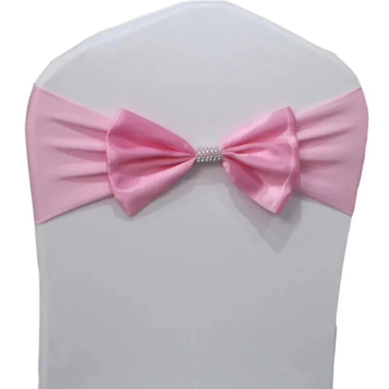Set of satin spandex chair sashes with elastic stretch bows for wedding and event decorations, shown in black on banquet chairs.