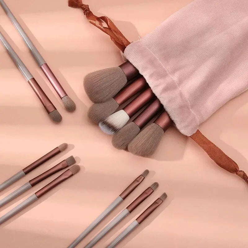 Showlu 13-piece makeup brush set with soft foundation, eye, and blush brushes in a black cosmetic bag for women.