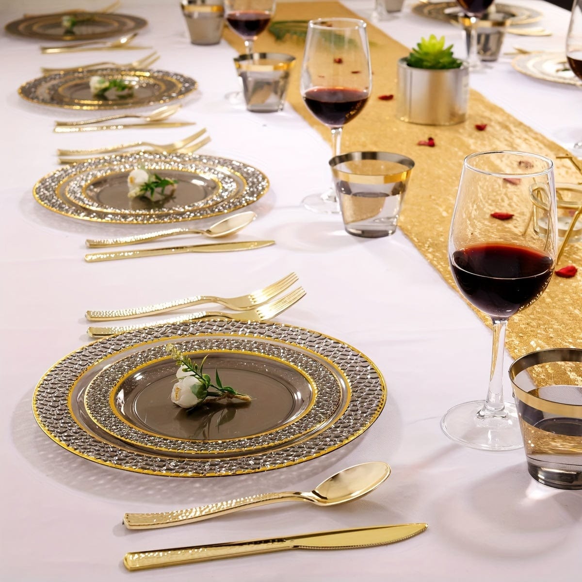 Showlu Fashion Store Nervure 150PCS gold and black plastic party plates with silverware set, including dinner plates, cups, and utensils.