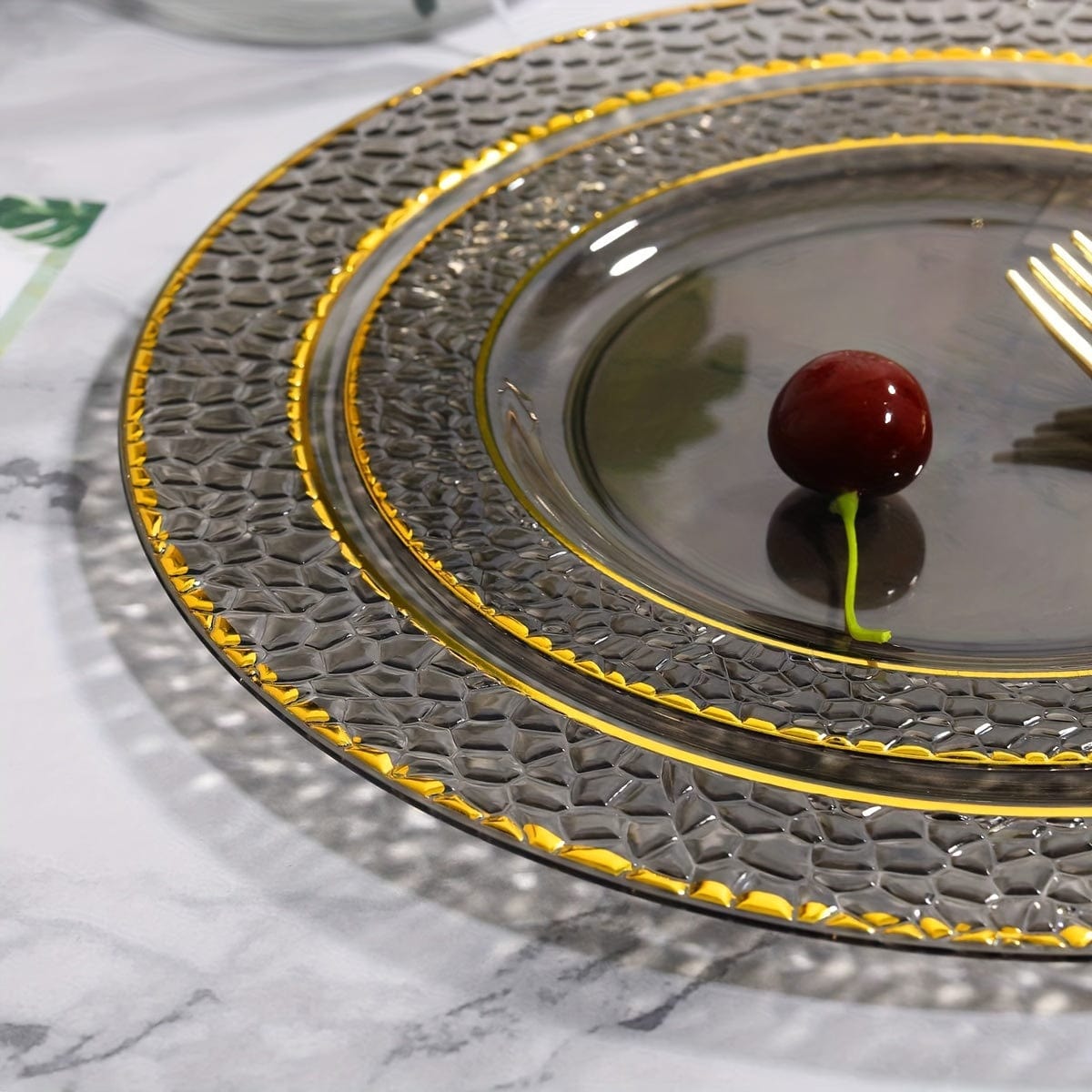 Set of 150 gold and black plastic party plates with silverware, including dinner, dessert plates, cups, forks, knives, and spoons