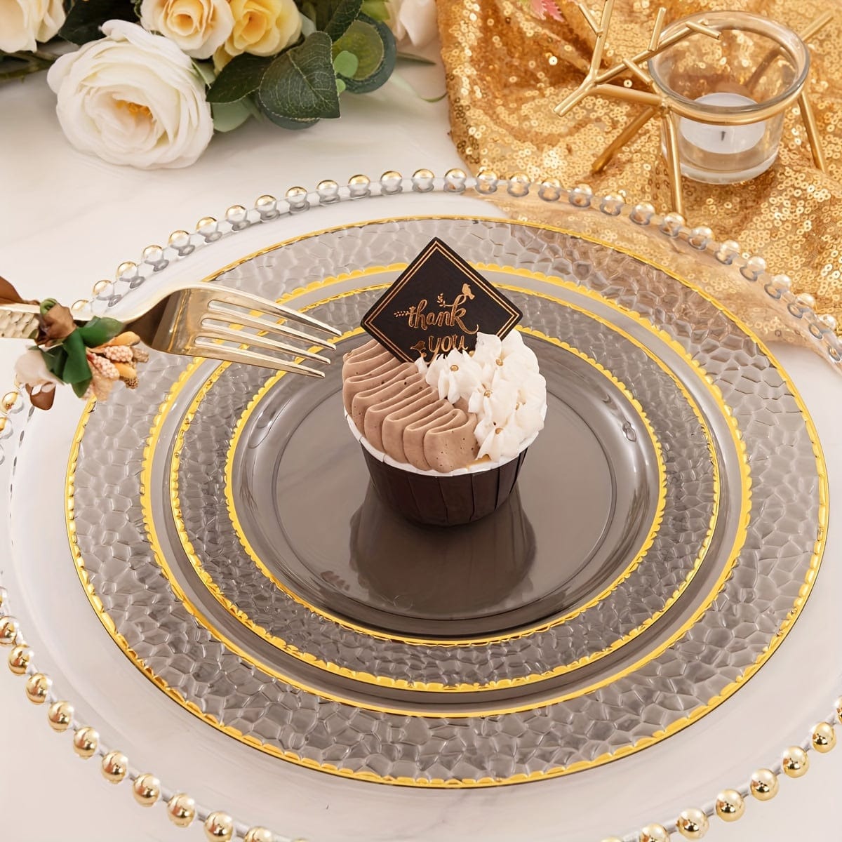 Set of 150 gold and black plastic party plates with silverware, including dinner and dessert plates, cups, forks, knives, and spoons