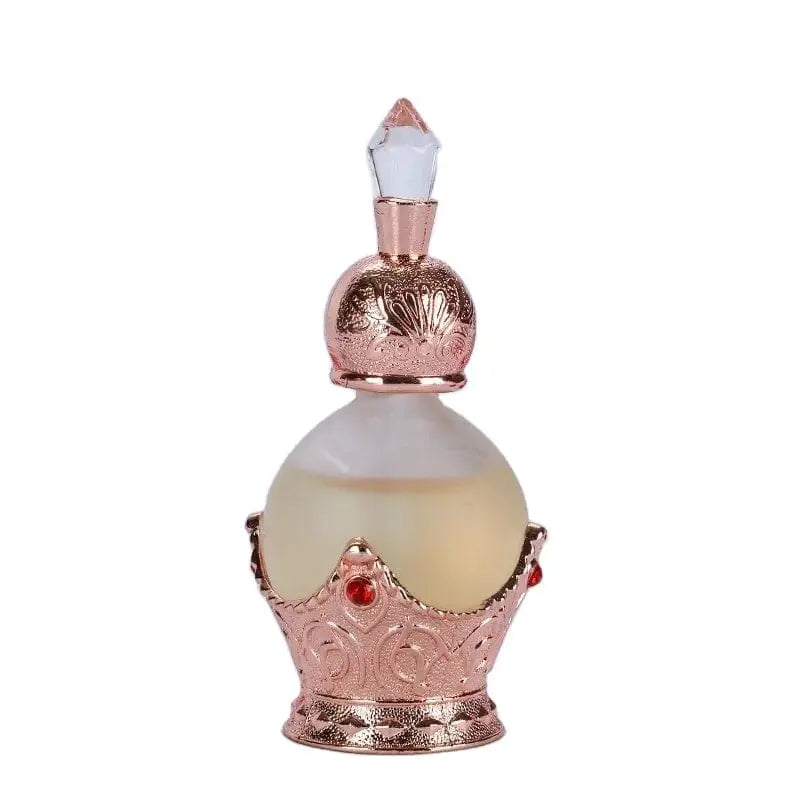 The 15ml oil perfume features a frosted glass bottle with a rose gold crown-shaped holder adorned with red gem-like accents and a clear faceted lid. Enjoy its long-lasting, fresh, and elegant fragrance for a beautiful life.
