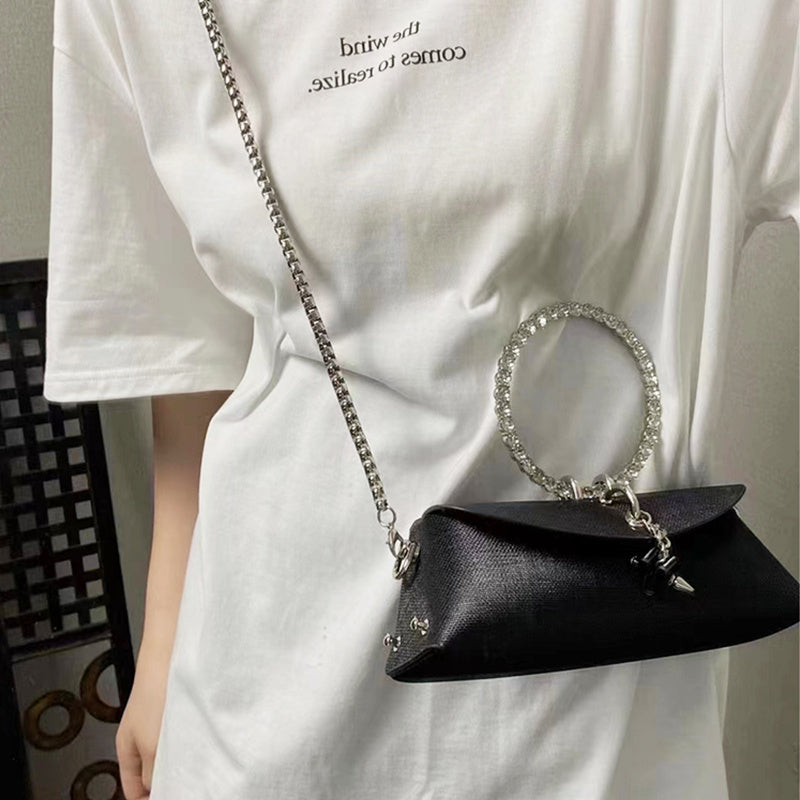 Shiny rhinestone clutch bag with faux leather exterior and chain strap, ideal for evening occasions and formal events.