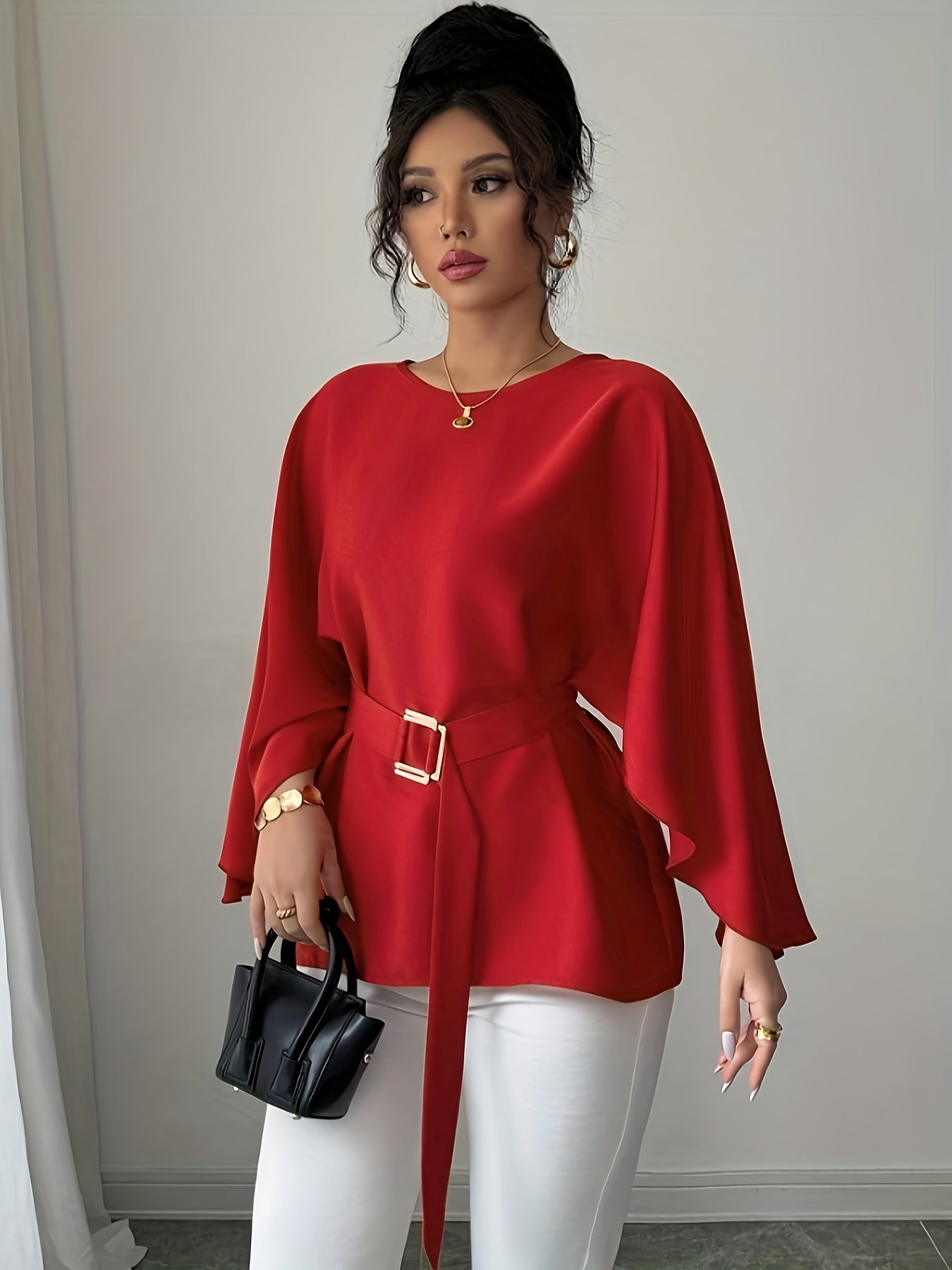 Light blue SHOWLU FASHION long sleeve belted blouse with elegant crew neck, displayed on a hanger, showcasing its stylish design.