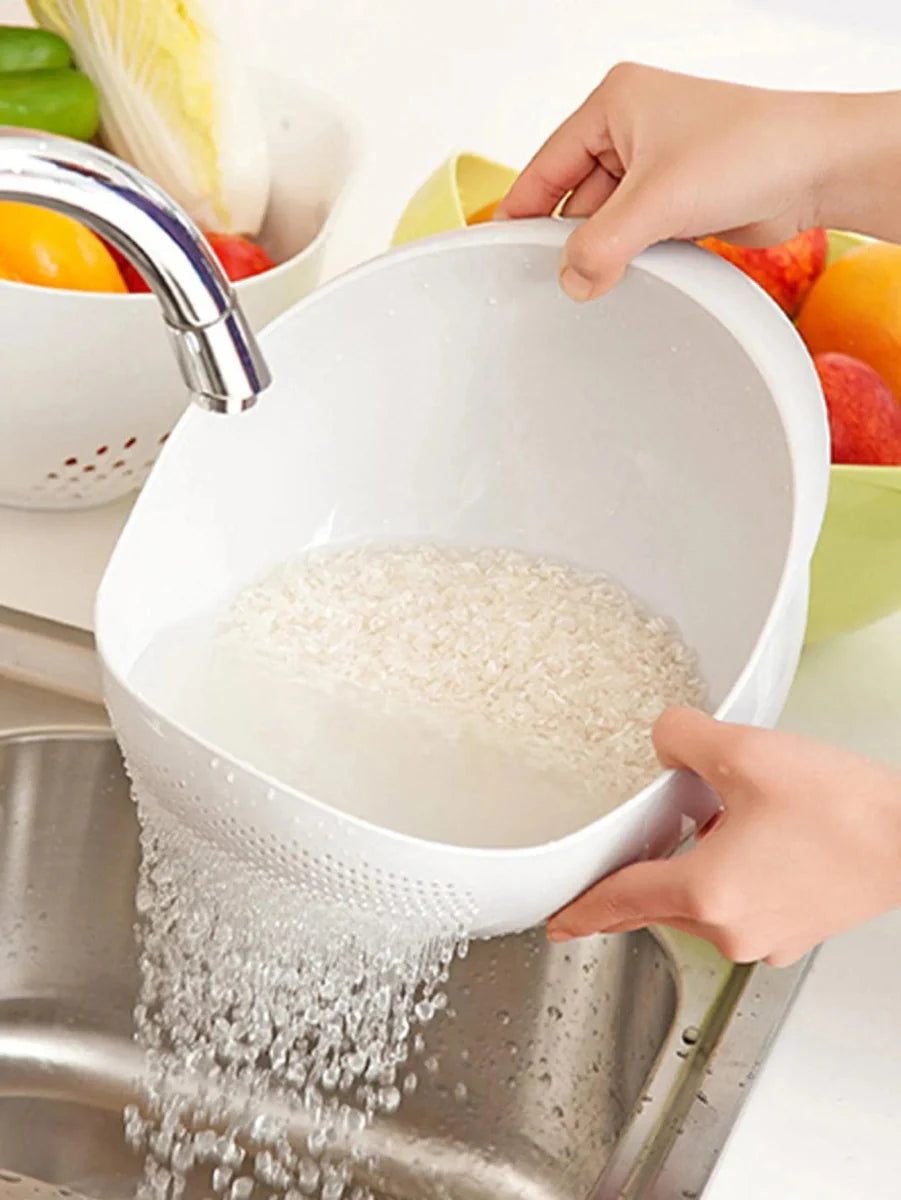 Showlu silicone rice drain basket with handle, used for washing fruits and draining rice in the kitchen.