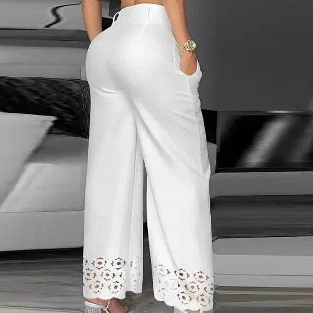 SHOWLU Women's 2-piece set featuring a V-neck cami crop top and hollow-out wide-leg high-waist pants in white.