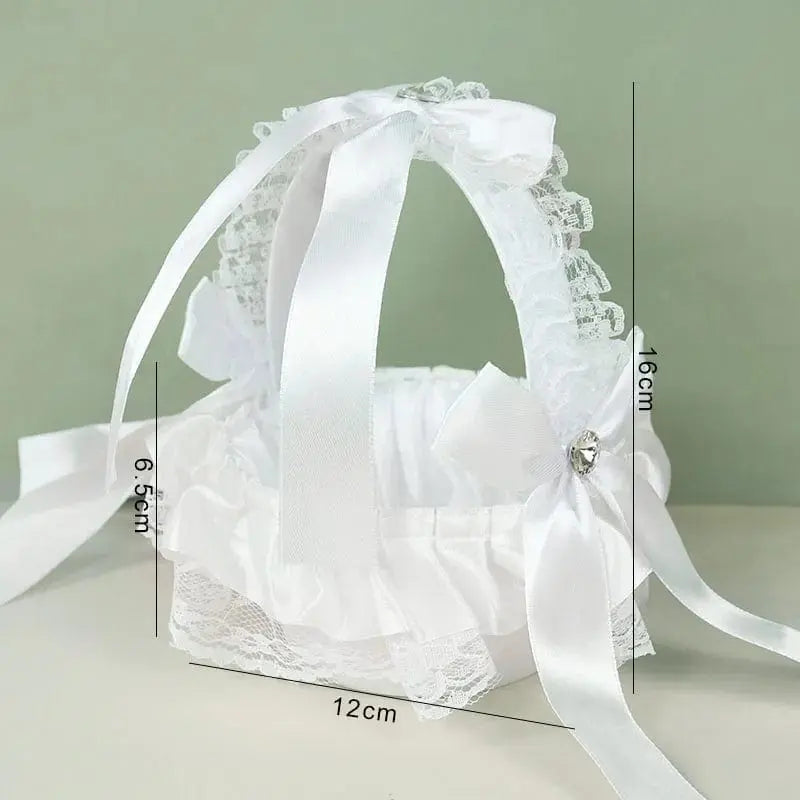 White silk flower girl basket from YONGSNOW, 20cm, perfect for wedding ceremony decor, held by a flower girl during the celebration.