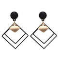 Showlu Korean geometric triangle tassel dangle earrings for women, featuring long statement design with vibrant colors and intricate details.