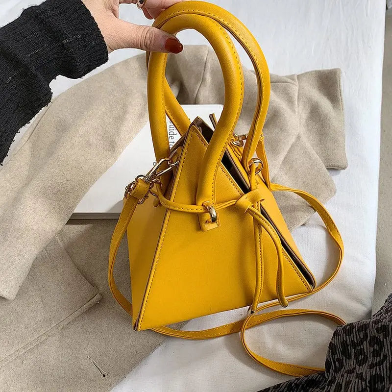 Chonghui women's triangle chain bucket bag made of PU leather, crossbody style with chain details and spacious interior.