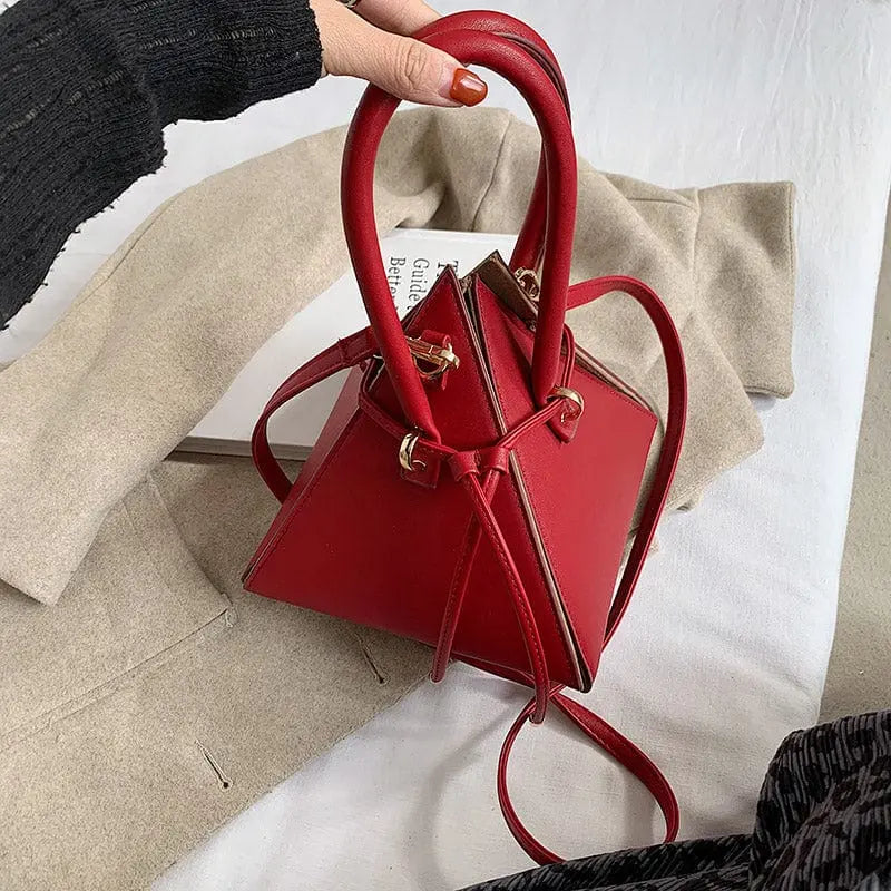 Chonghui women's triangle chain bucket bag made of PU leather, crossbody handbag with a stylish design and metal chain strap.