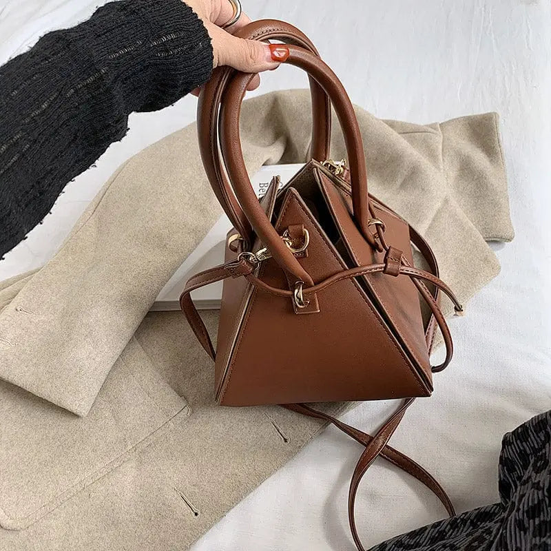 Chonghui women's triangle chain bucket bag in PU leather, crossbody style with a trendy design and gold-tone chain strap.