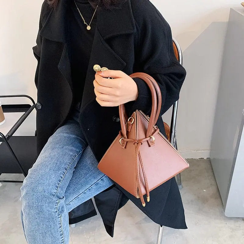 Chonghui women's triangle chain bucket bag made of PU leather, crossbody style with chain details, stylish women's handbag.