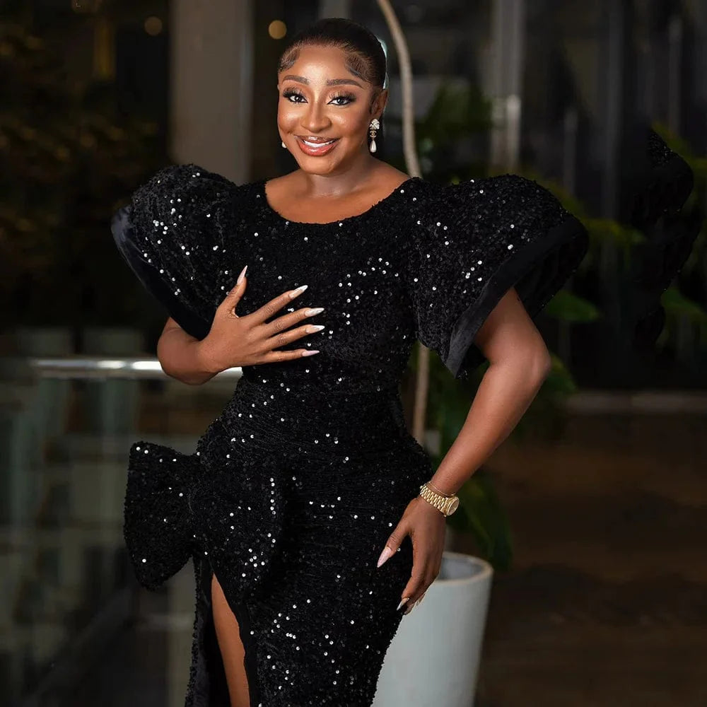 Amunyelia black sequin evening dress with puffed sleeves, high slit, round neckline, and fishtail design for elegant events.