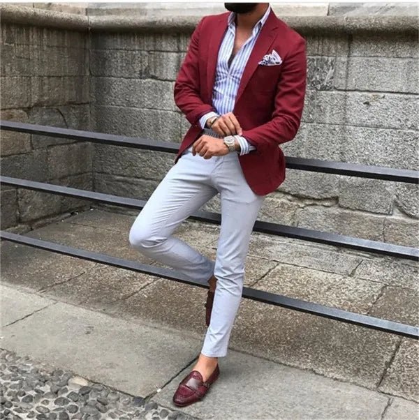 Burgundy red slim fit men's tuxedo suit with matching jacket and pants, designed for formal occasions and weddings.