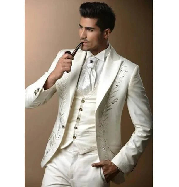 White embroidery men's 3-piece wedding suit featuring slim fit tuxedo jacket, pants, and vest for grooms and formal occasions.