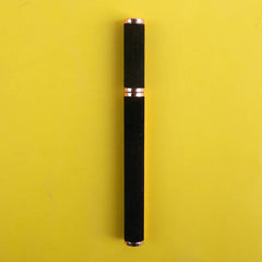 A black eyeliner pen with rose gold accents centered against a bright yellow background.