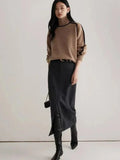 Elegant women's knitted hoodie with turtleneck and lantern sleeves, showing a warm, stylish autumn-winter sweater from SHOWLU FASHION.