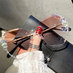 Rimless gradient sunglasses featuring decorative rhinestones along the edges of the lenses.