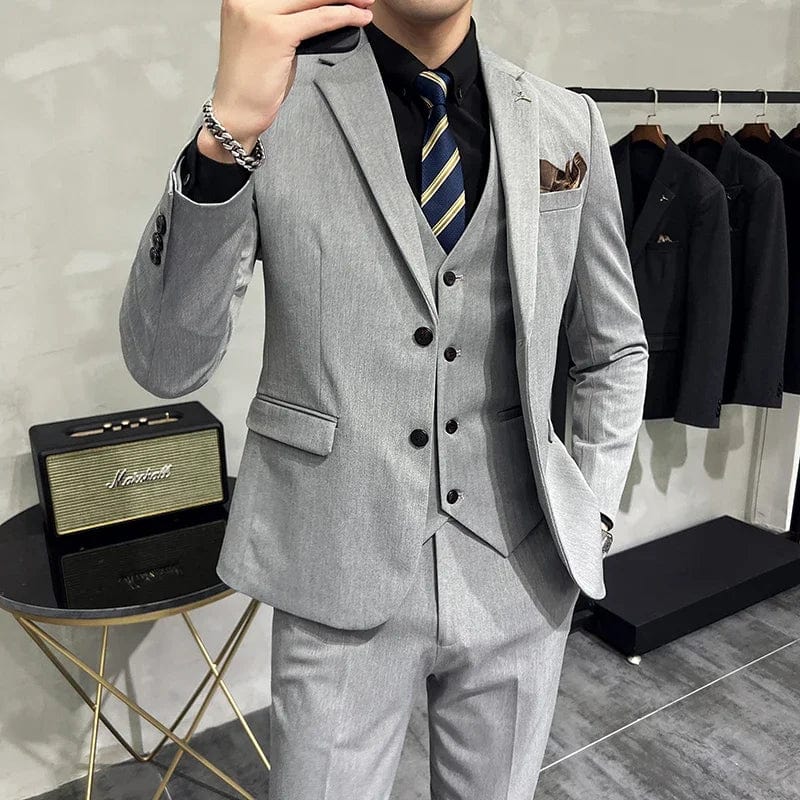 Men's slim fit business suit by Showlu Fashion, includes jacket, vest, and pants in solid color with striped details.
