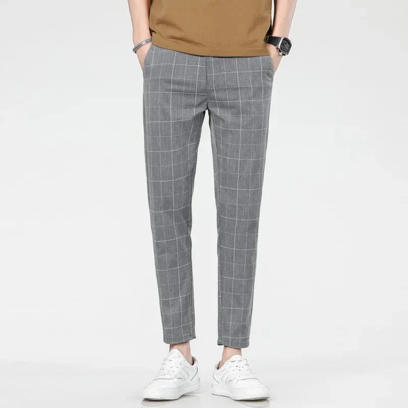 Men's plaid slim fit sweatpants with side stripes, mid-waist design, casual style, and checkered pattern from Showlu Fashion.